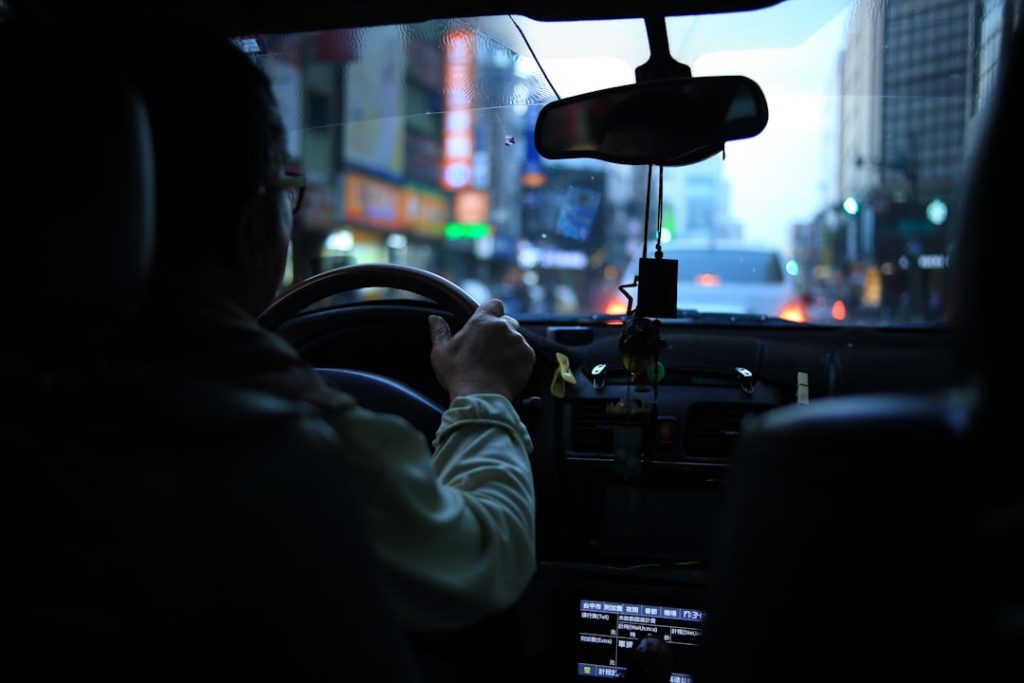 man-driving-car-with-bokeh-lights-bmhrththq-q